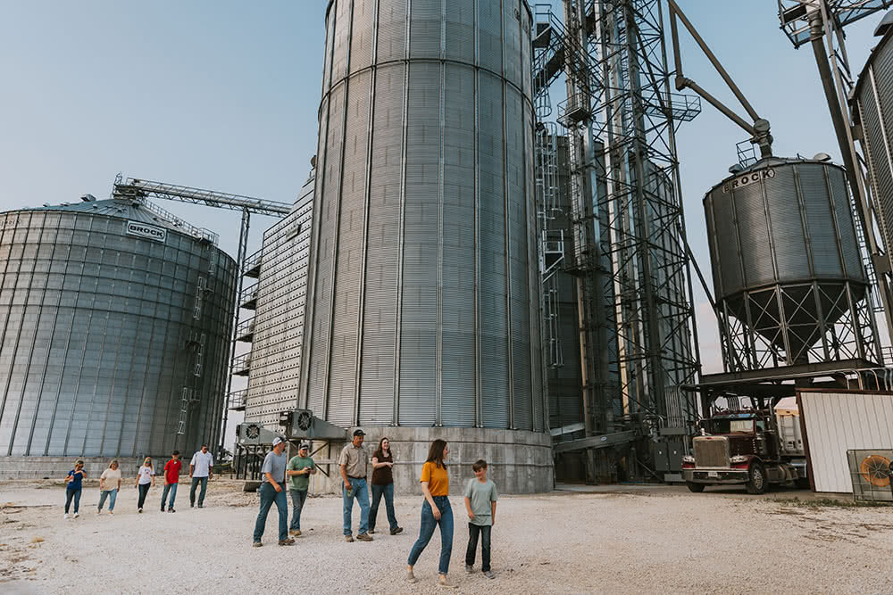 Family-Walking Niemeyer Family Farm walking by grain bins